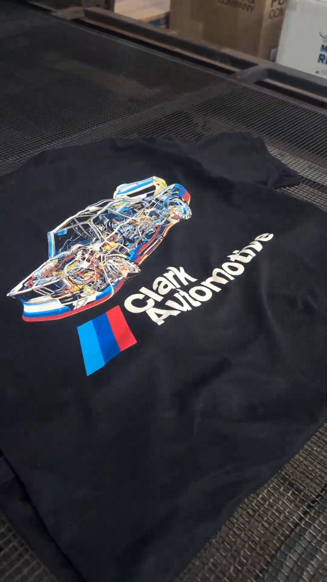 The completed Clark Automotive design printed on a black shirt at our home shop.